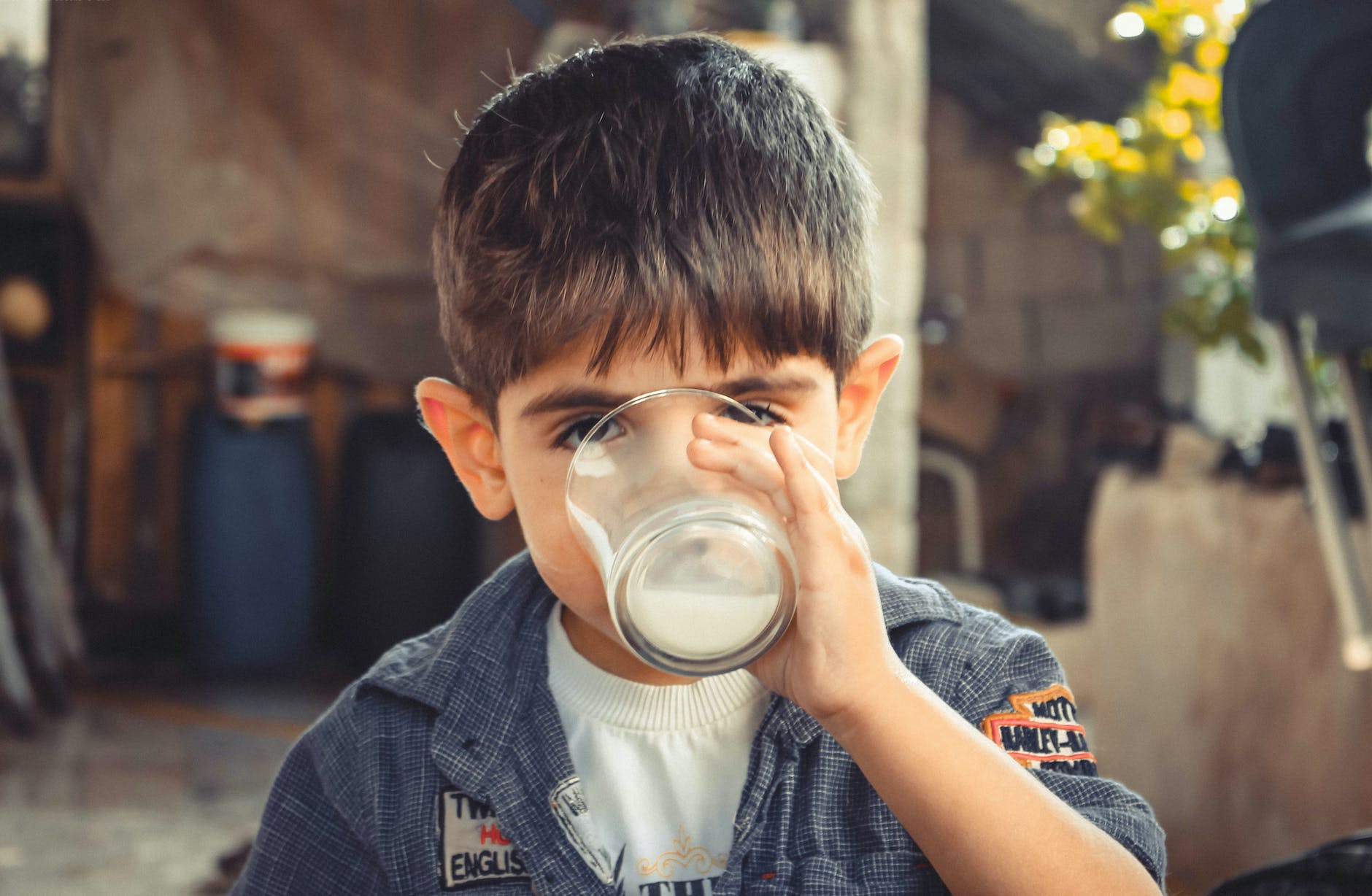 photo of boy drinking glass of milk